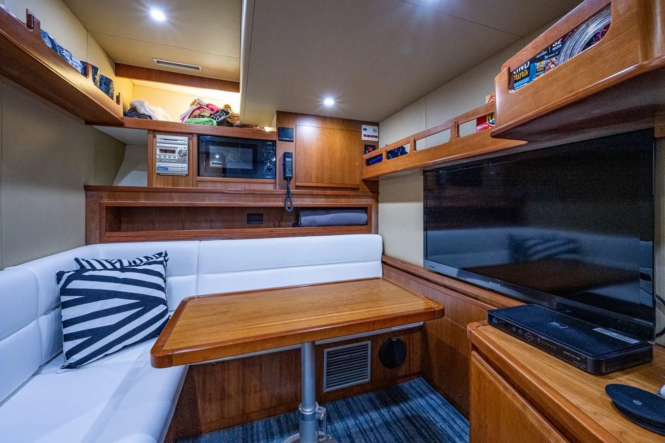 a room with a bed and a table aboard EVERYTHING GOOD Yacht for Sale