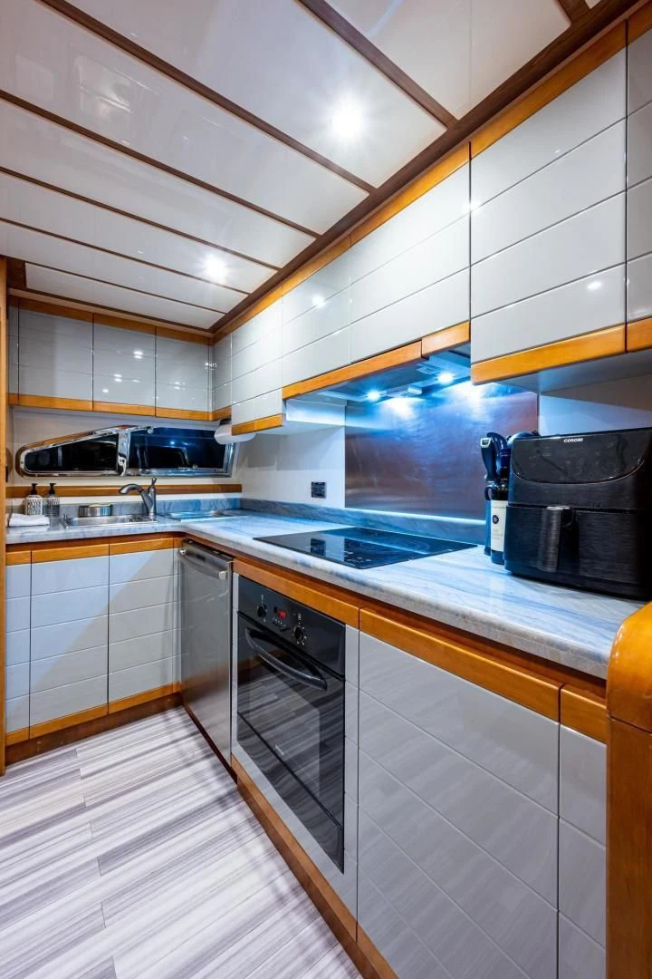 a kitchen with white cabinets aboard EVERYTHING GOOD Yacht for Sale