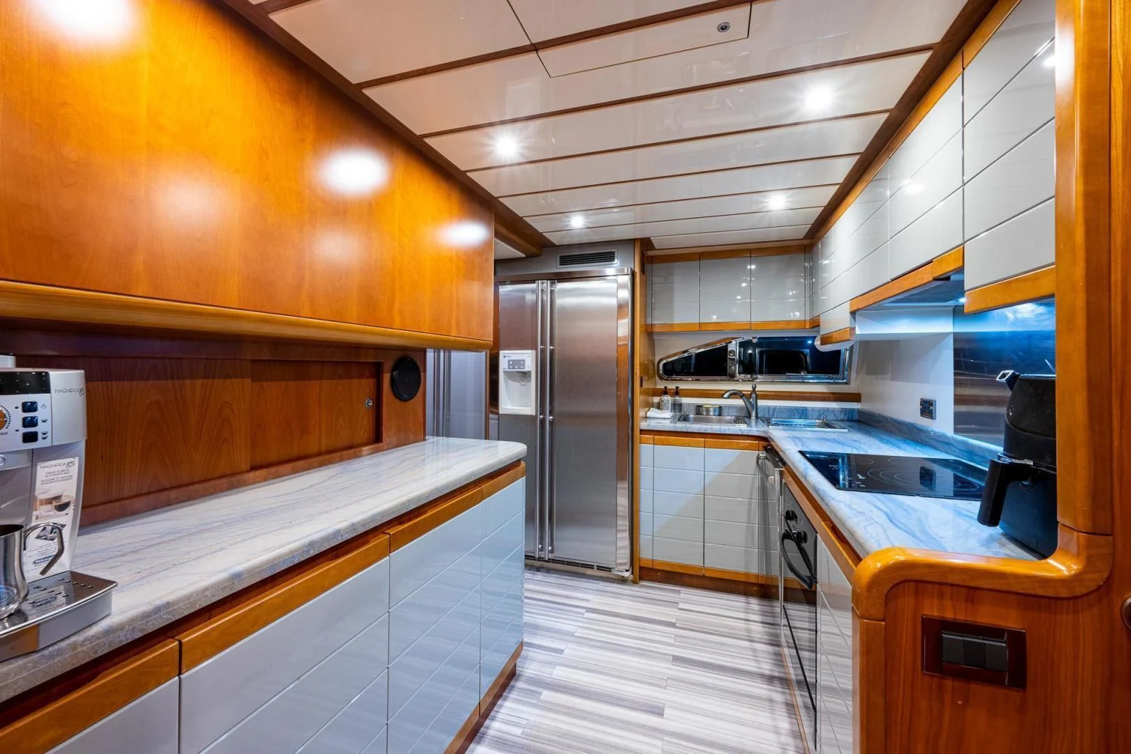 a kitchen with a stainless steel refrigerator aboard EVERYTHING GOOD Yacht for Sale