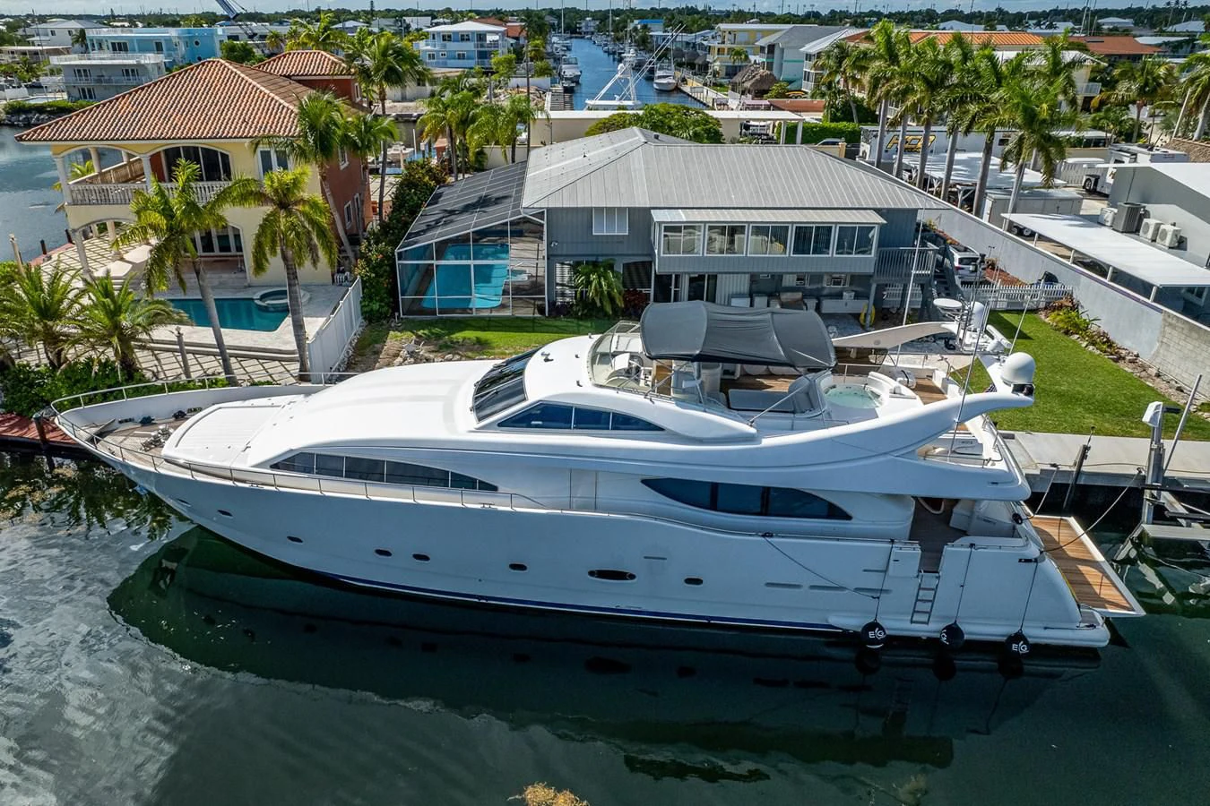 a white boat in a harbor aboard EVERYTHING GOOD Yacht for Sale
