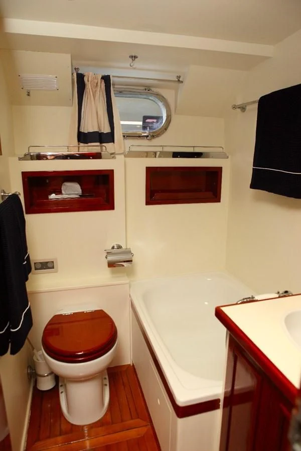 a bathroom with a toilet and sink aboard UNICA Yacht for Sale