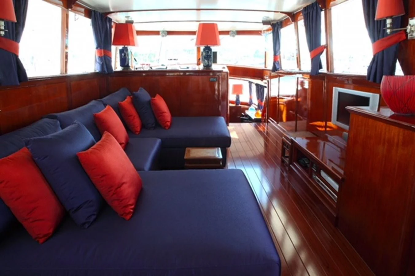 a blue couch in a room aboard UNICA Yacht for Sale