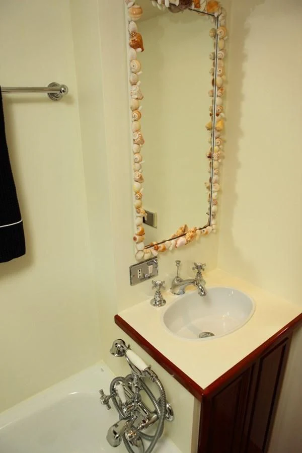 a bathroom with a sink and a mirror aboard UNICA Yacht for Sale