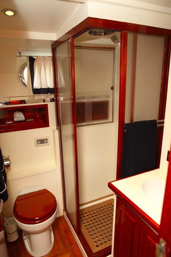 a bathroom with a shower unit and a toilet aboard UNICA Yacht for Sale