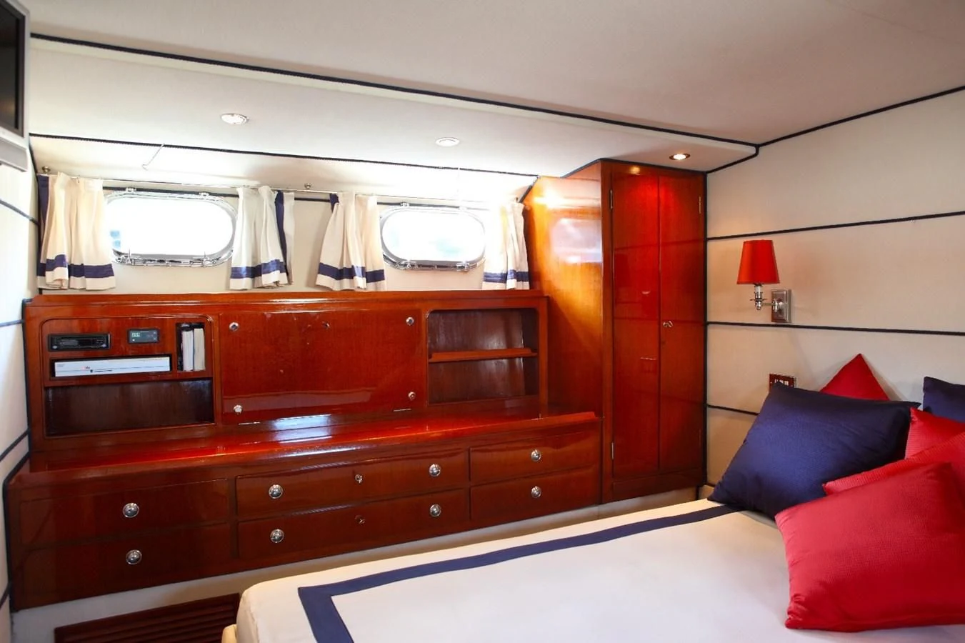 a bedroom with a bed and a dresser aboard UNICA Yacht for Sale