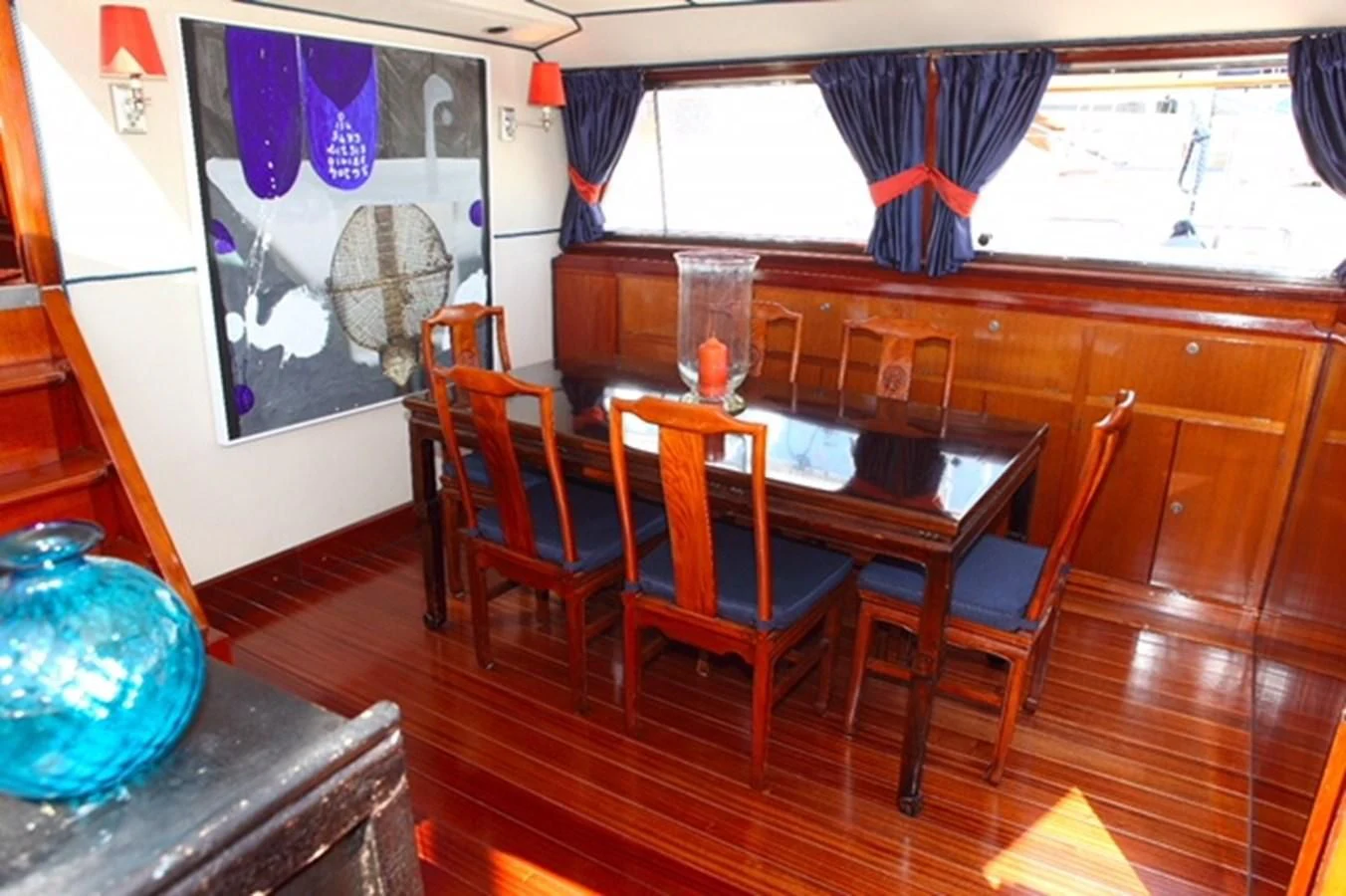 a dining table and chairs in a room aboard UNICA Yacht for Sale