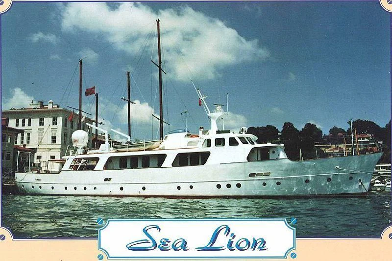 a white boat in a harbor aboard SEALION Yacht for Sale