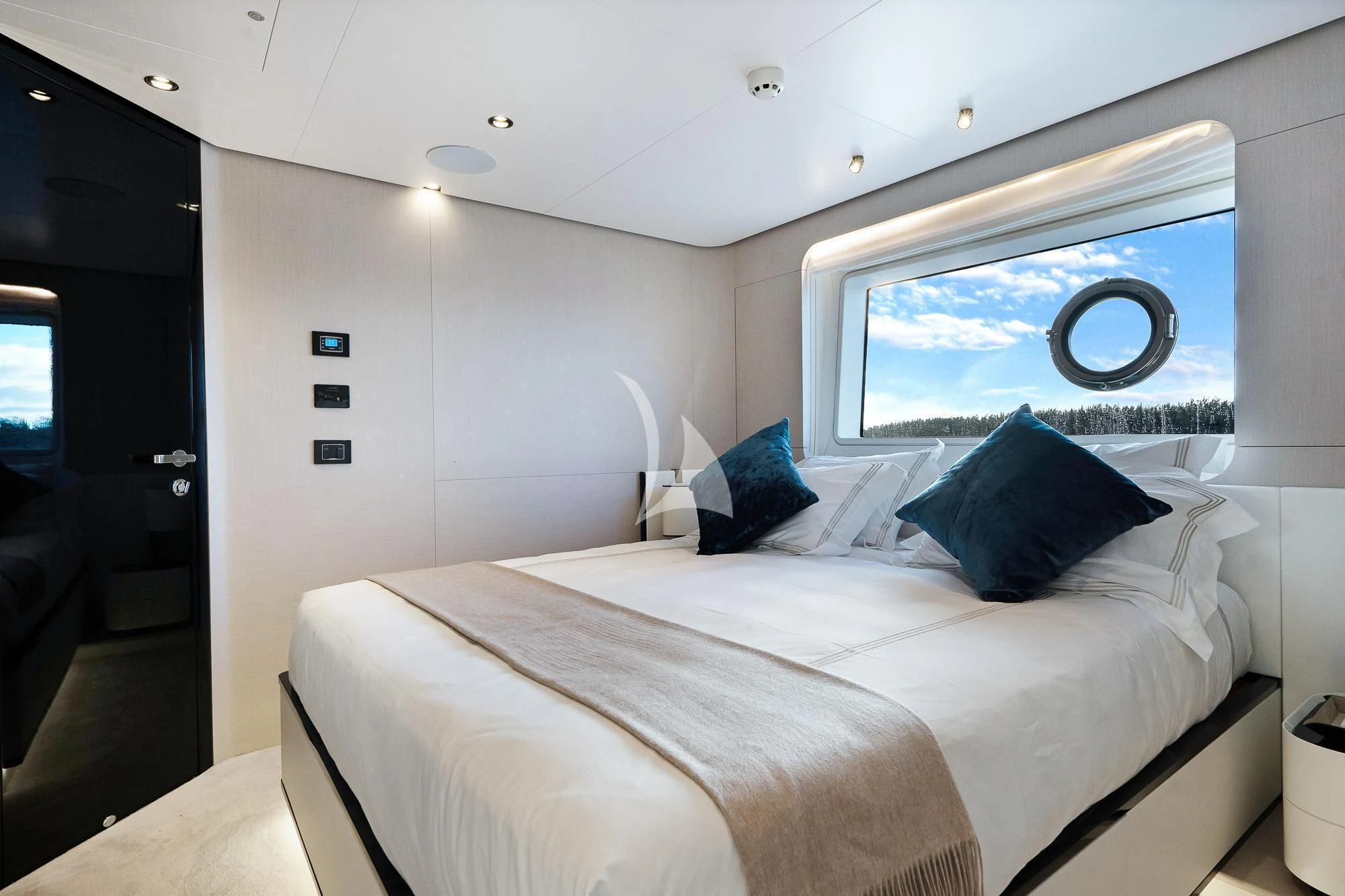 a bed with a large painting on the wall aboard SEA OWL Yacht for Sale