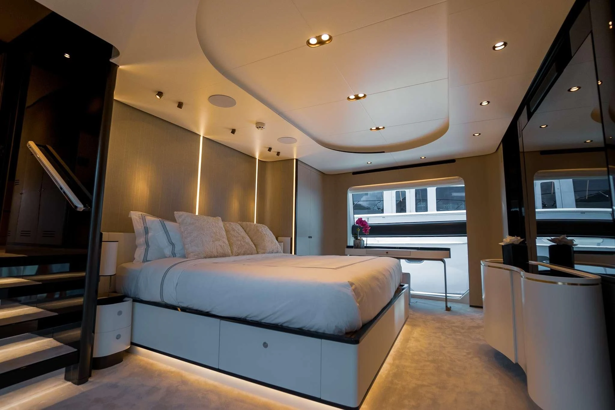 a bedroom with a bed and a staircase aboard SEA OWL Yacht for Sale