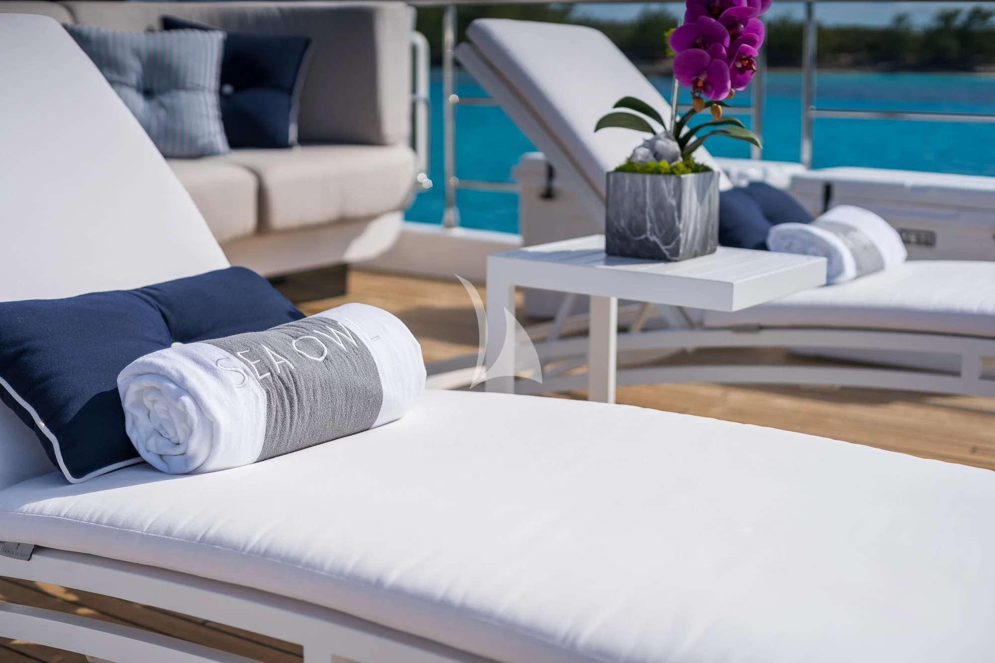 a white coffee table with a purple flower on it aboard SEA OWL Yacht for Sale