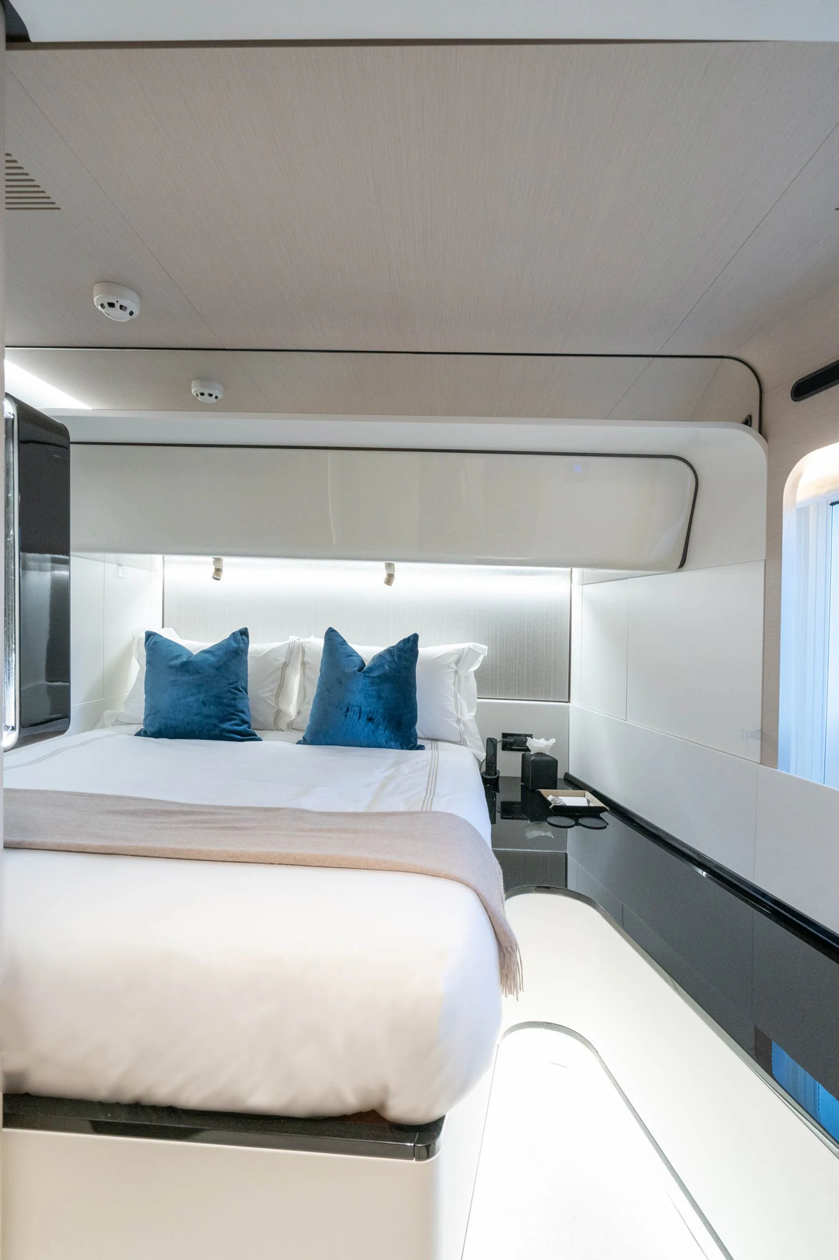 a bed with a white bed spread aboard SEA OWL Yacht for Sale