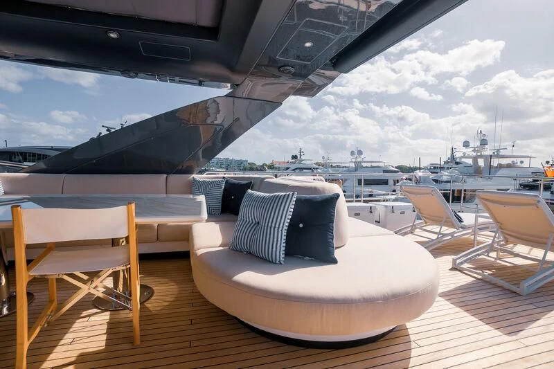 a room with a table chairs and a large ship in the background aboard SEA OWL Yacht for Sale