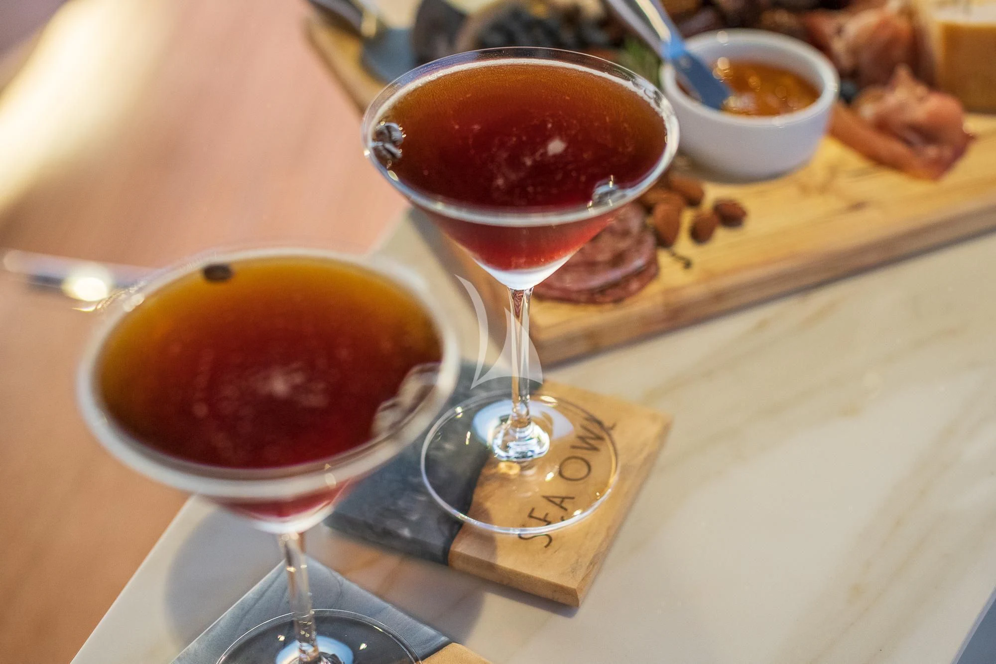 a couple of glasses of red wine on a table aboard SEA OWL Yacht for Sale