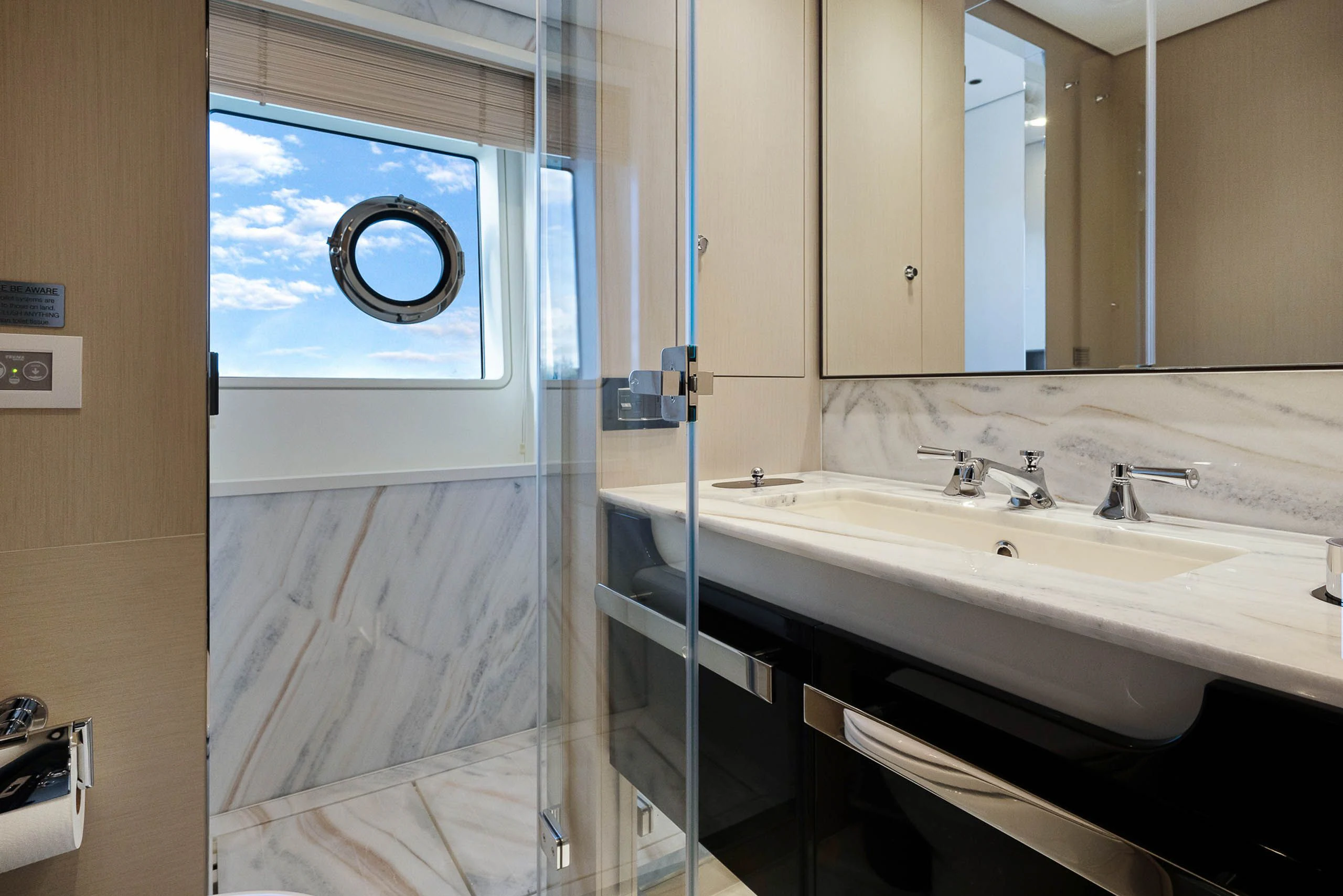 a bathroom with a glass shower aboard SEA OWL Yacht for Sale