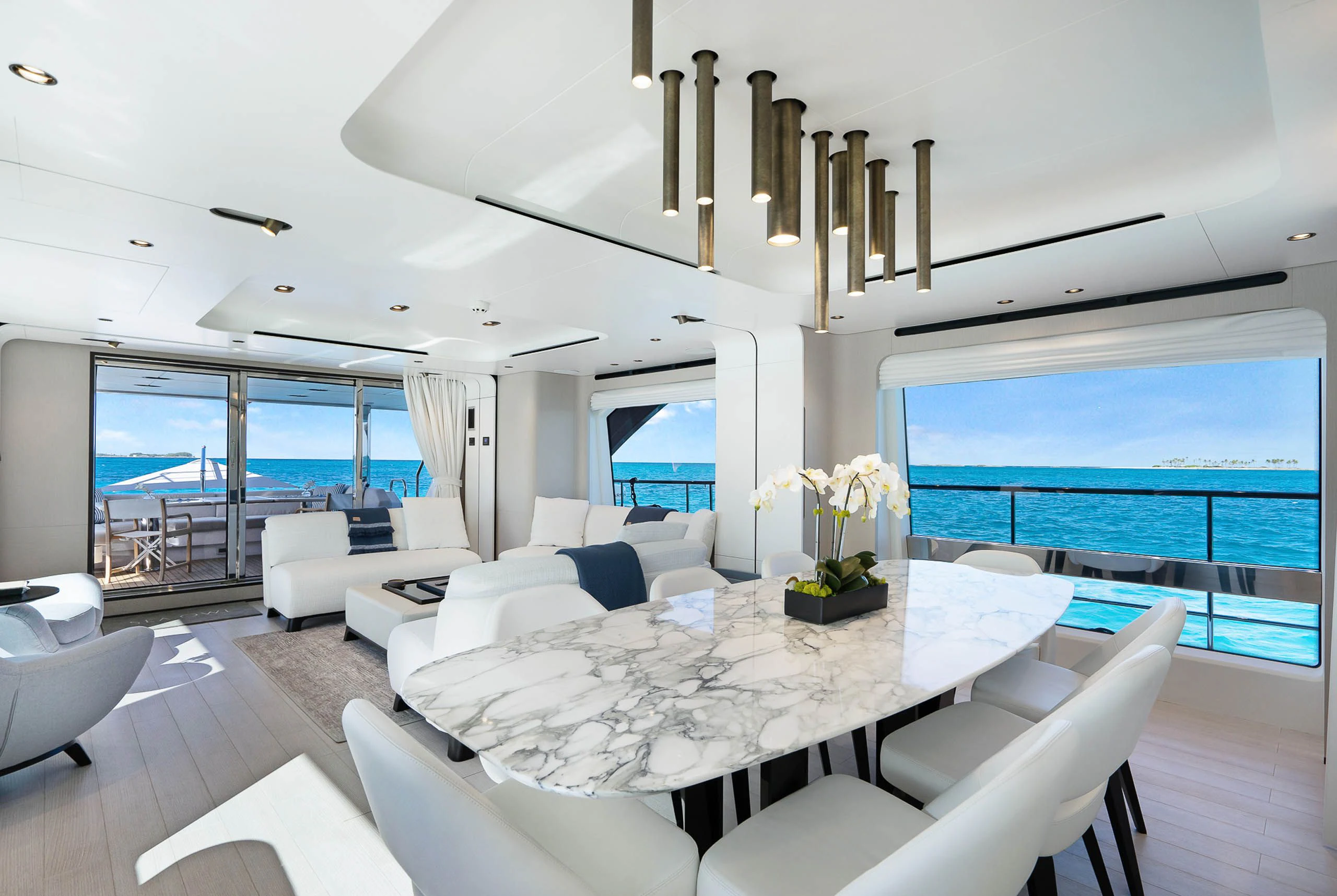 a room with a table chairs and a view of the ocean aboard SEA OWL Yacht for Sale