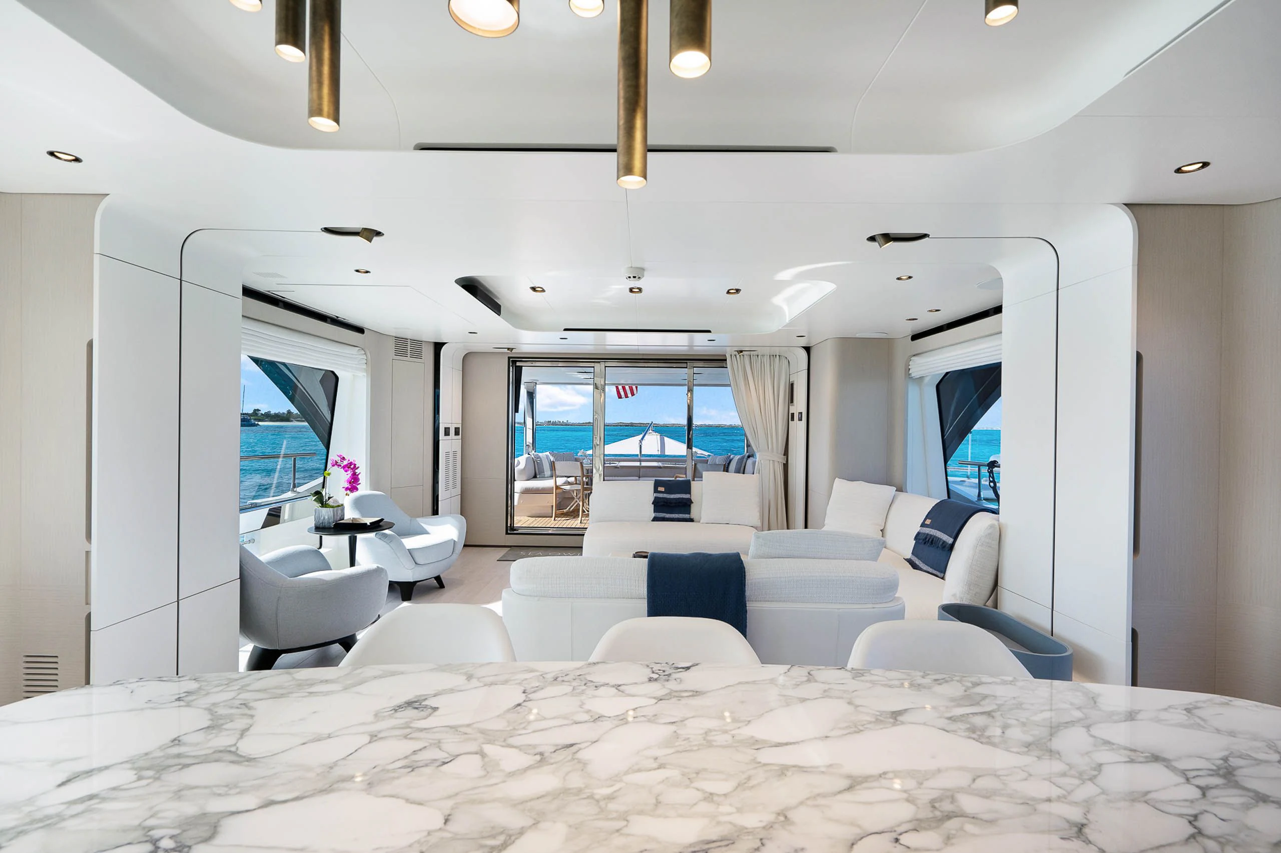 a large white room with a large bed and a large window aboard SEA OWL Yacht for Sale