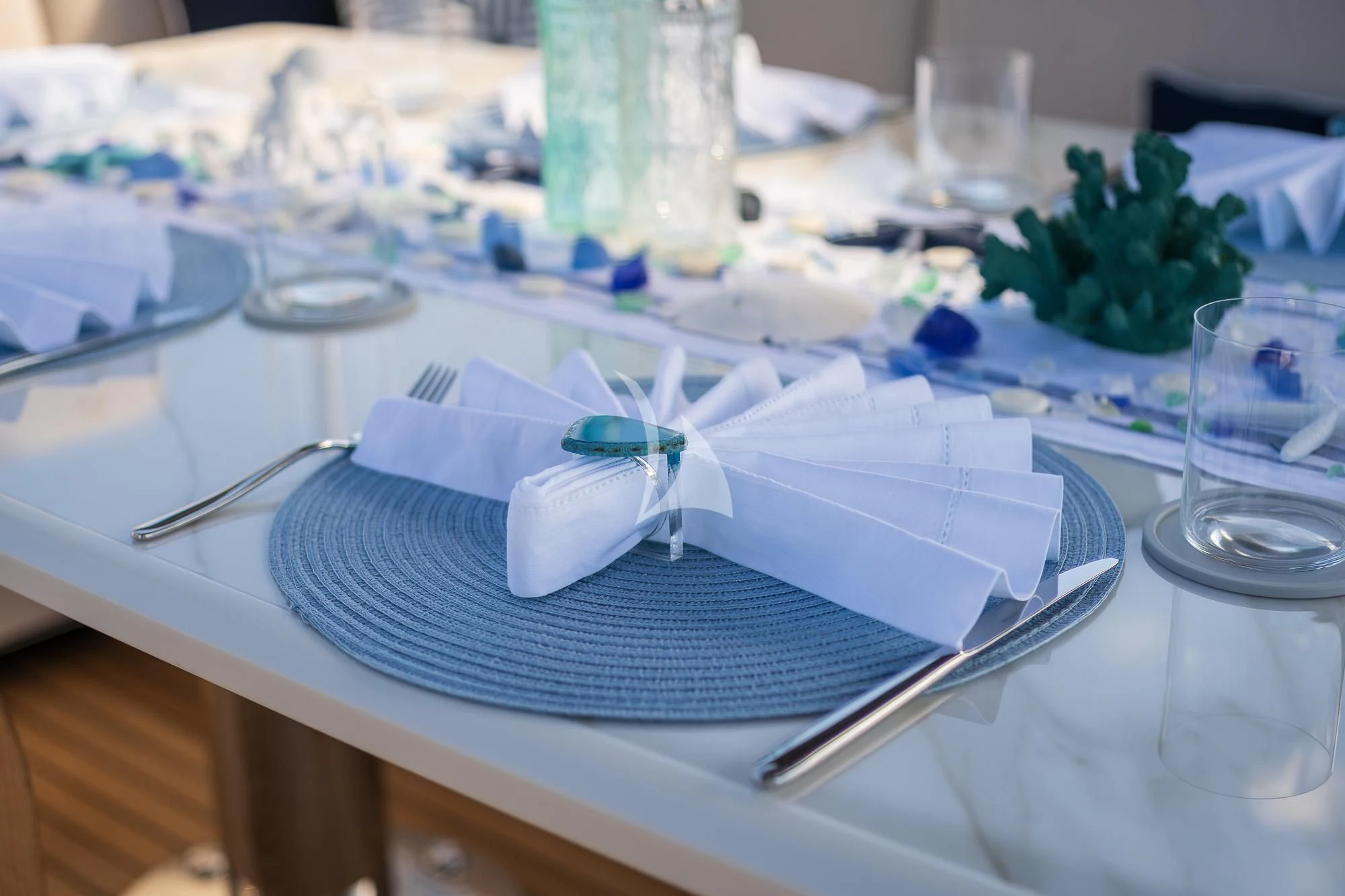 a table with plates and glasses aboard SEA OWL Yacht for Sale