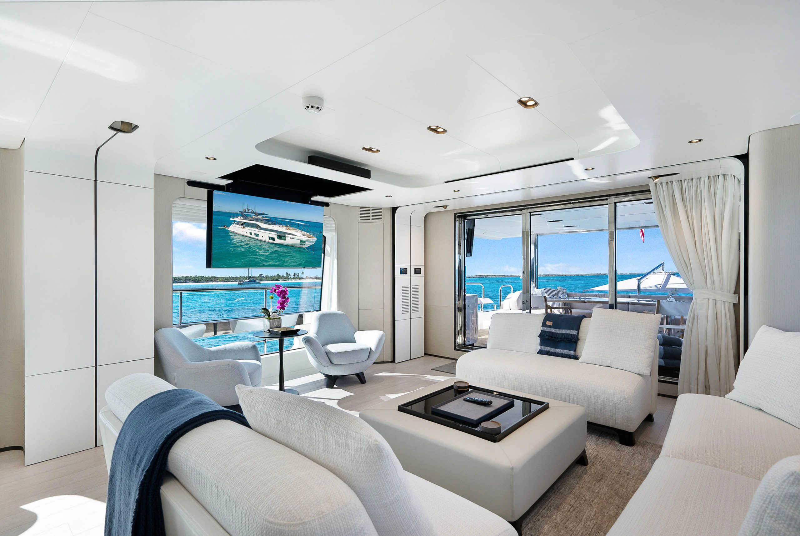 a living room with a large screen aboard SEA OWL Yacht for Sale