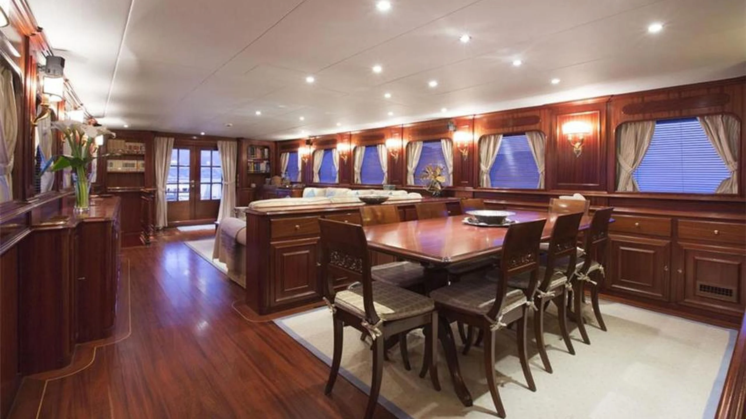 a large room with a table and chairs aboard MIZAR Yacht for Sale