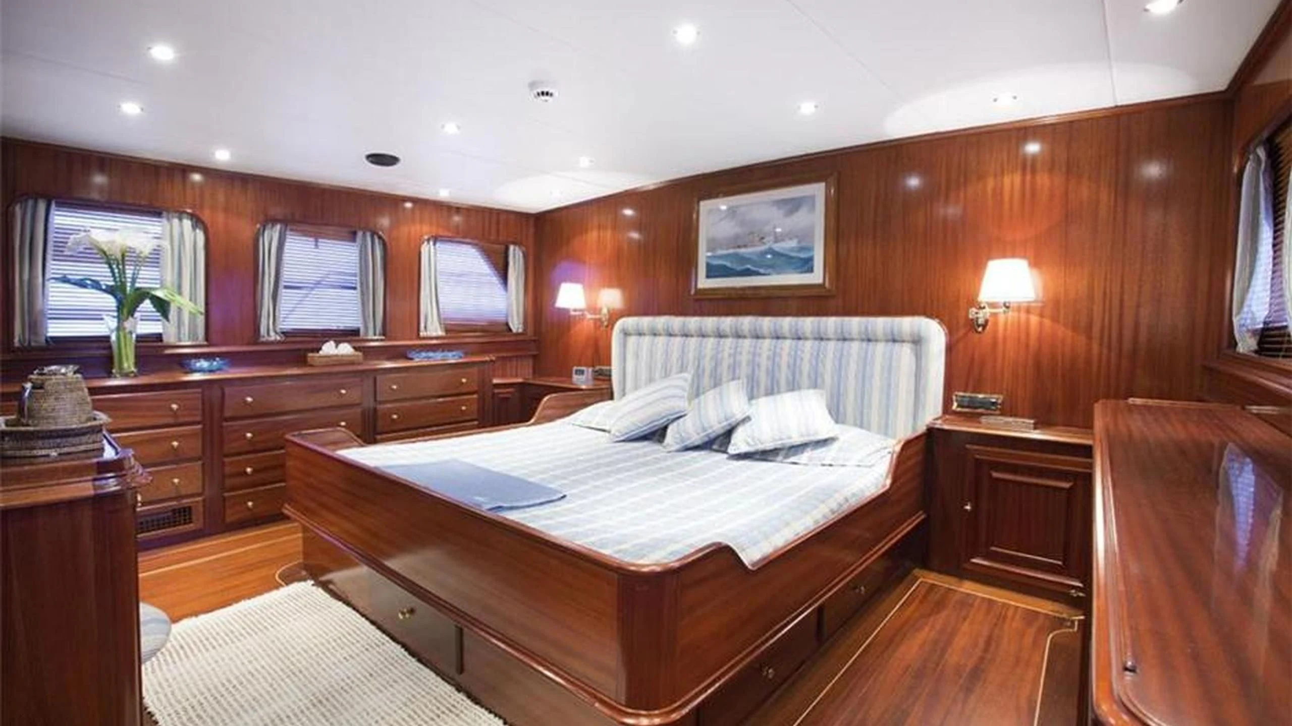 a bedroom with a bed and a desk aboard MIZAR Yacht for Sale