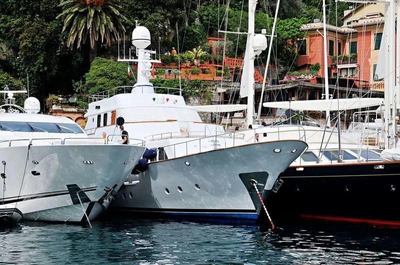 a couple of boats are parked in the water aboard MIZAR Yacht for Sale