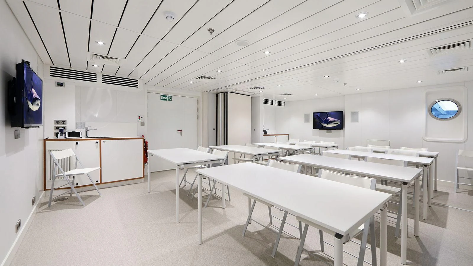 a room with tables and chairs aboard YERSIN Yacht for Charter