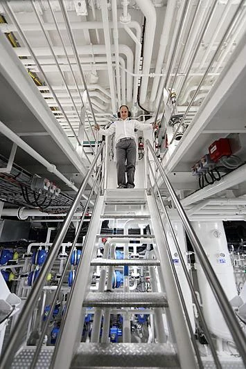 a person standing on a ladder aboard YERSIN Yacht for Charter