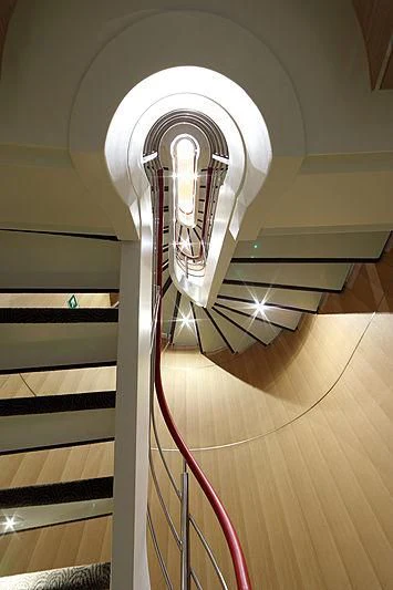 a staircase with a spiral staircase aboard YERSIN Yacht for Charter
