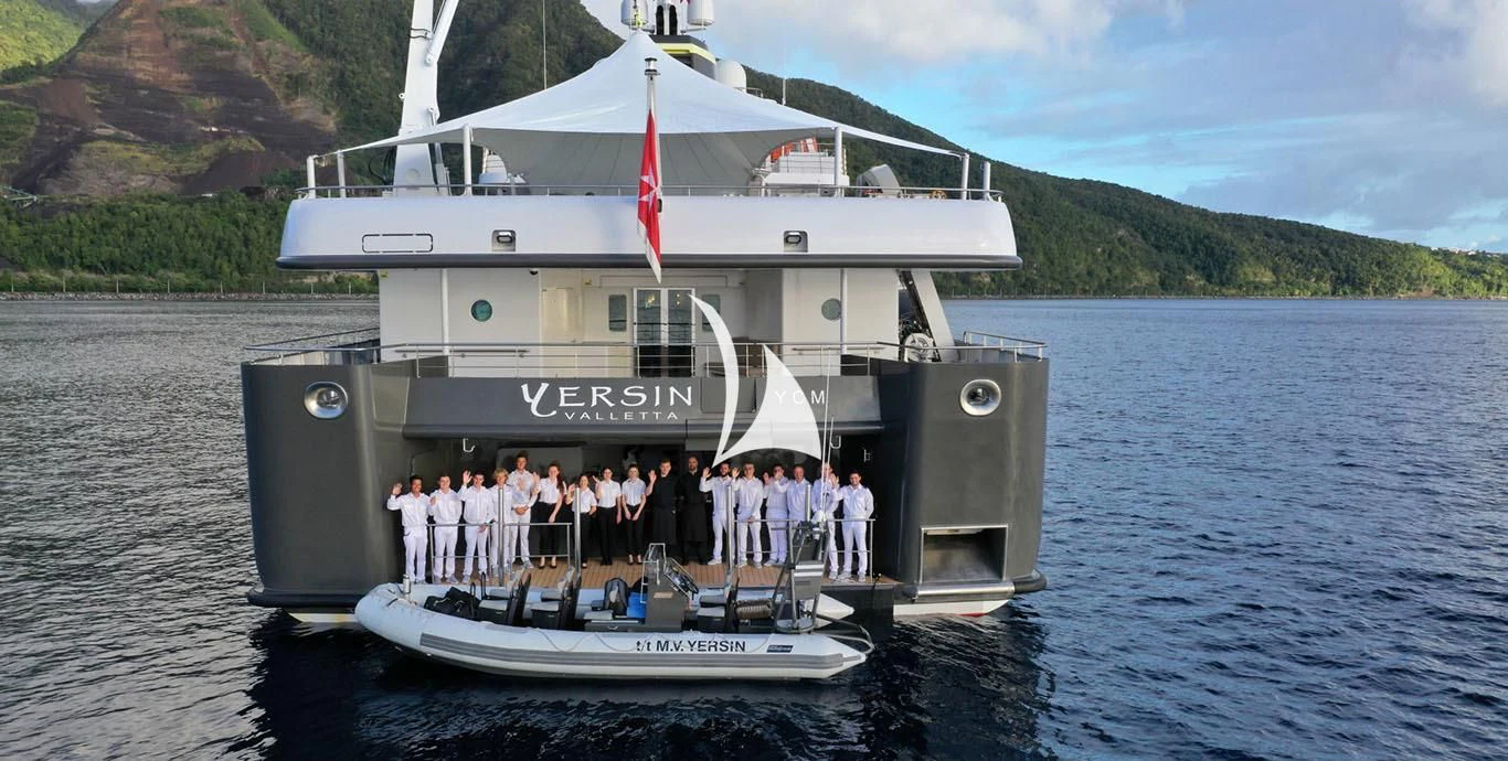 a group of people standing on a boat in the water aboard YERSIN Yacht for Charter