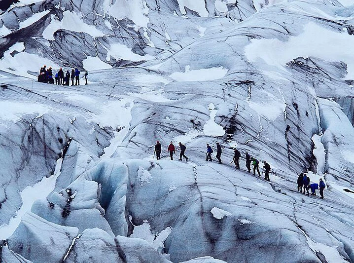a group of people climbing a snowy mountain aboard YERSIN Yacht for Charter