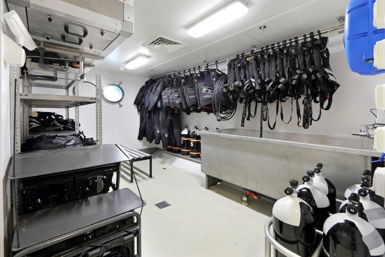a room with a large display of clothes on the wall aboard YERSIN Yacht for Charter