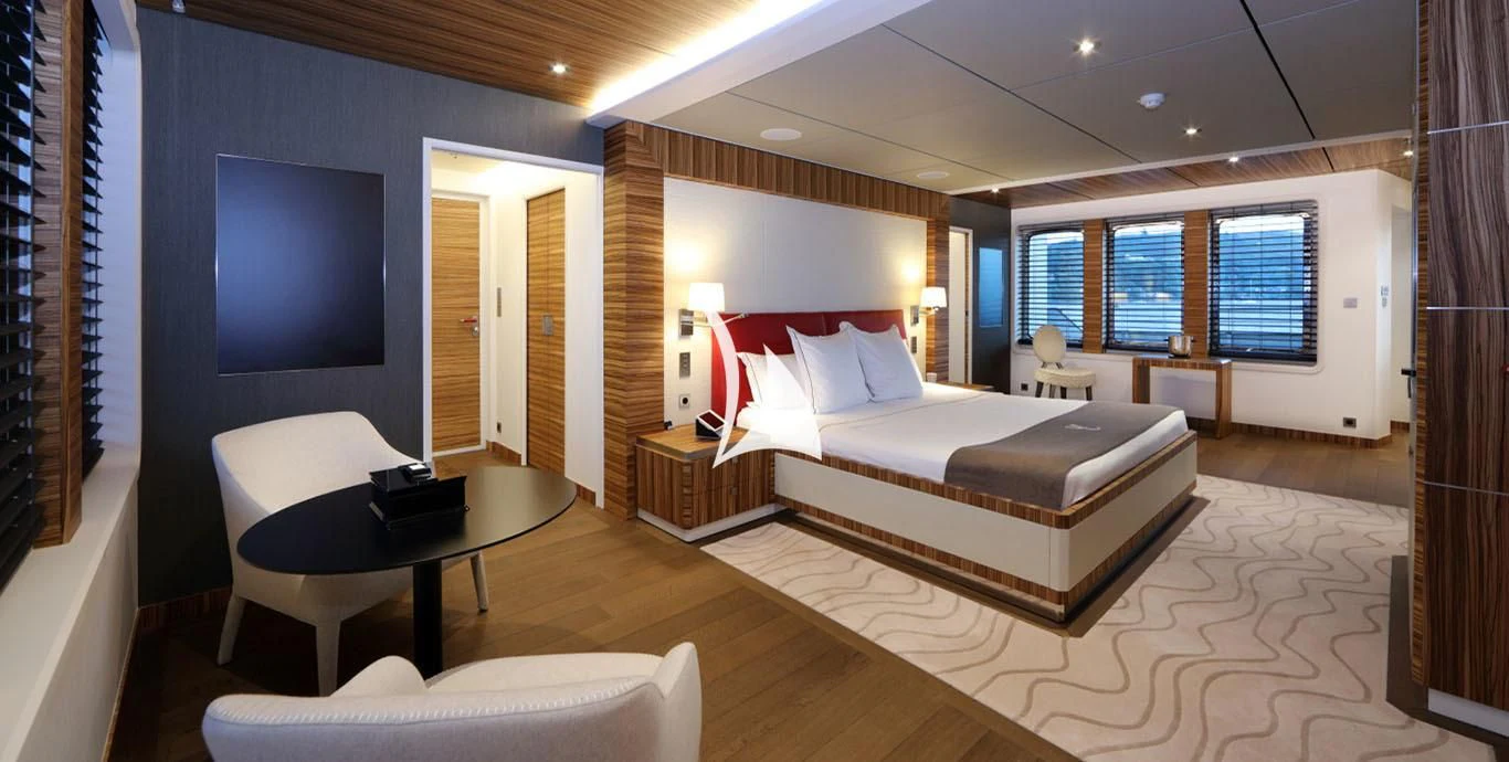 a large room with a bed and a tv aboard YERSIN Yacht for Charter