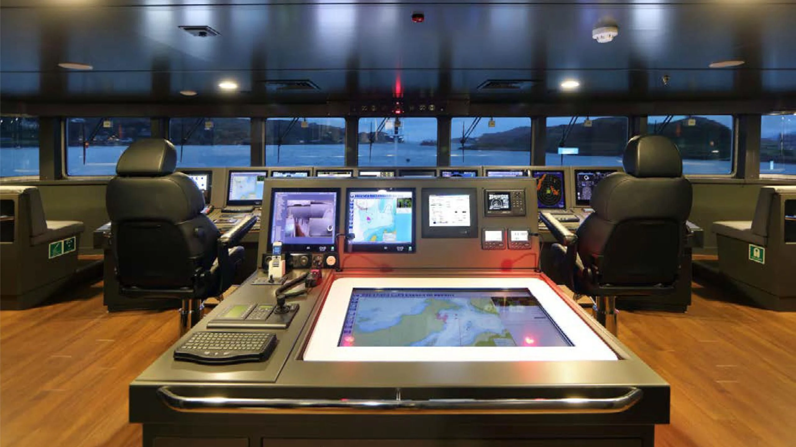 a room with a table with computers on it aboard YERSIN Yacht for Charter