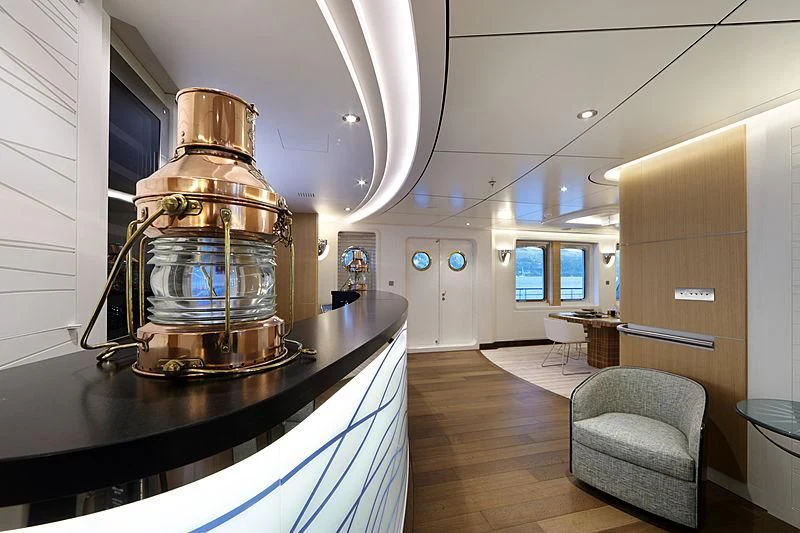 a large kitchen with a large metal mixer on a black counter aboard YERSIN Yacht for Charter