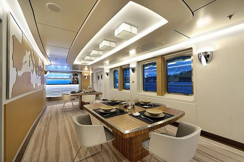 a room with a table and chairs aboard YERSIN Yacht for Charter