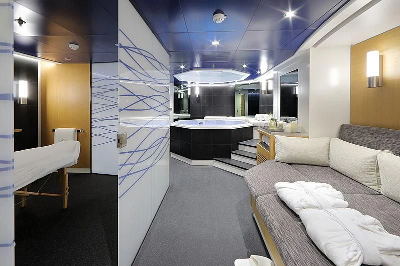 a room with a bed and a large mirror aboard YERSIN Yacht for Charter