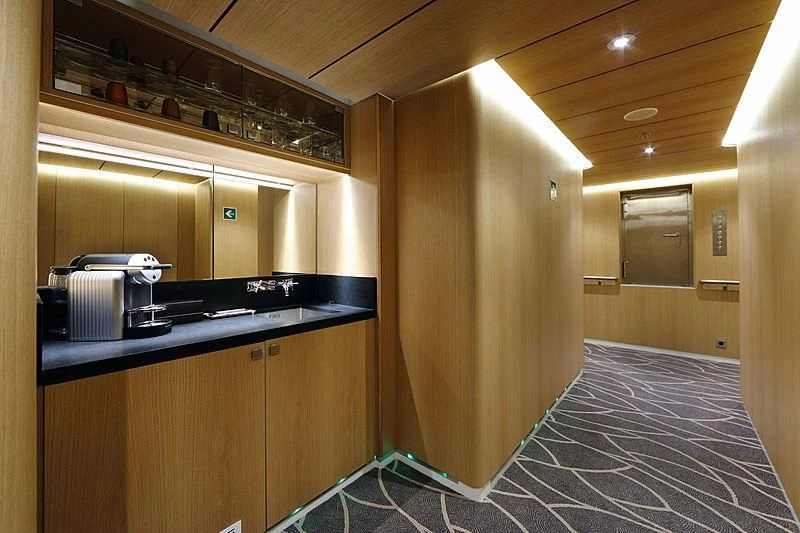 a kitchen with a wood wall aboard YERSIN Yacht for Charter