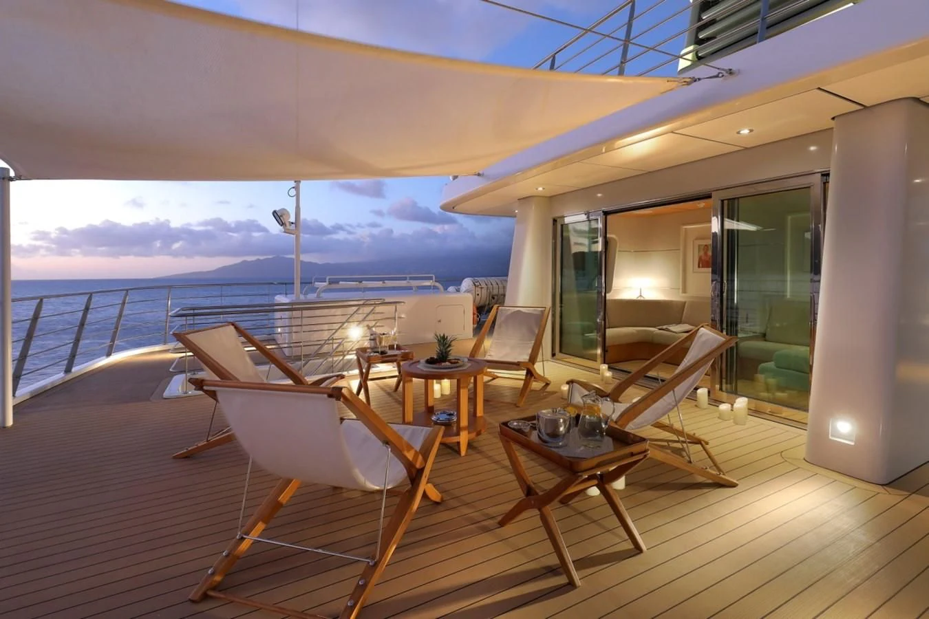 a room with a table and chairs on a deck aboard YERSIN Yacht for Charter