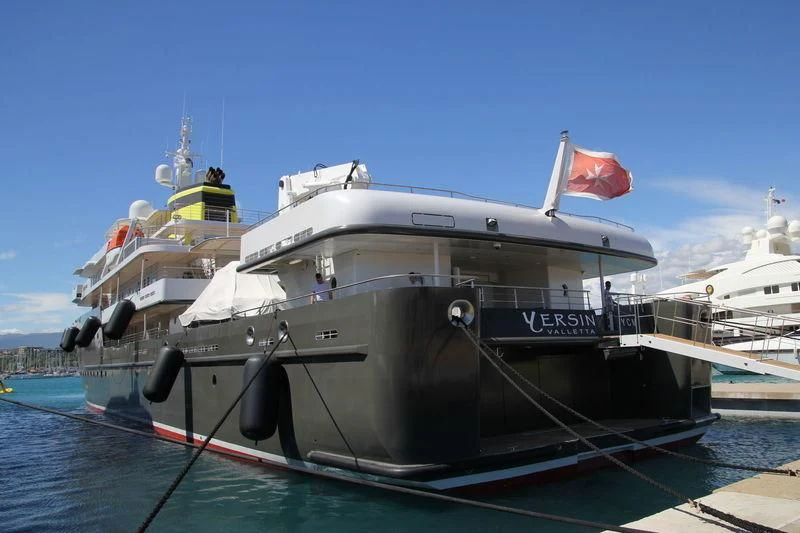 a large boat with a flag on it aboard YERSIN Yacht for Charter
