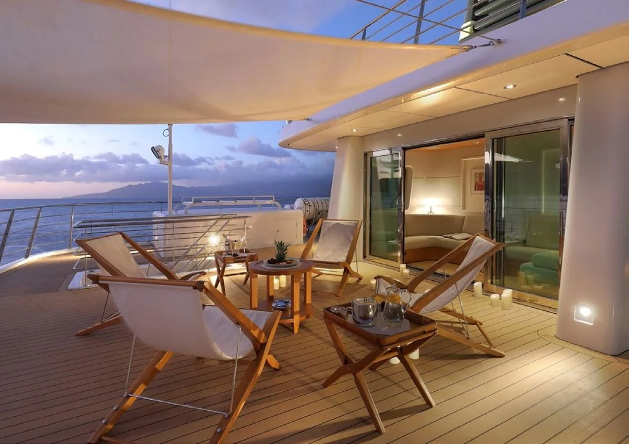 a room with a table chairs and a view of the ocean aboard YERSIN Yacht for Charter