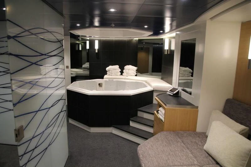 a bathroom with a tub and a couch aboard YERSIN Yacht for Charter