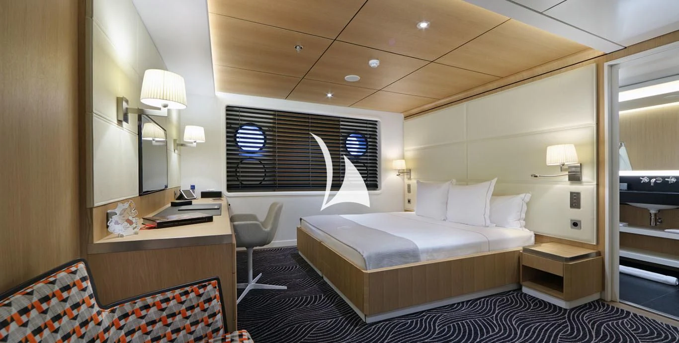 a hotel room with a bed and a desk aboard YERSIN Yacht for Charter