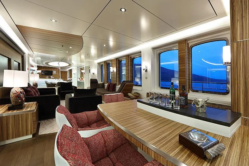 a living room with a table and a tv aboard YERSIN Yacht for Charter
