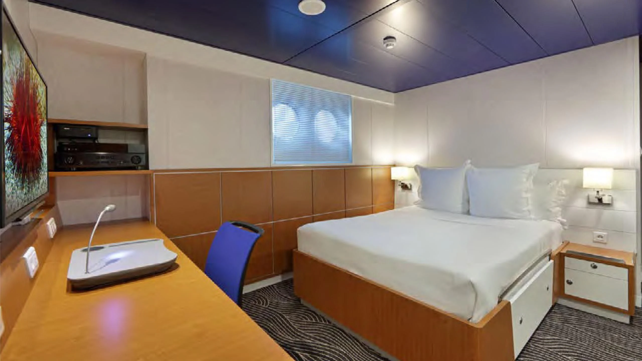 a room with a bed and a desk aboard YERSIN Yacht for Charter