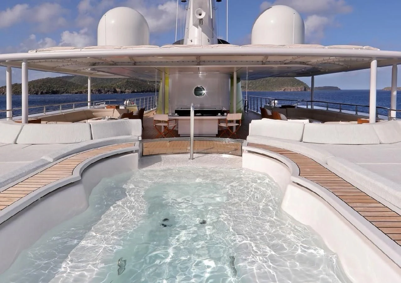 a swimming pool with a large building in the background aboard YERSIN Yacht for Charter