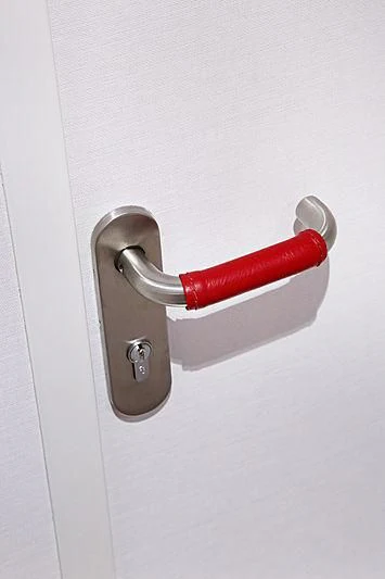 a red and silver door handle aboard YERSIN Yacht for Charter