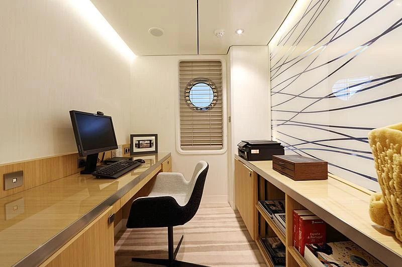 a room with a desk and computer aboard YERSIN Yacht for Charter