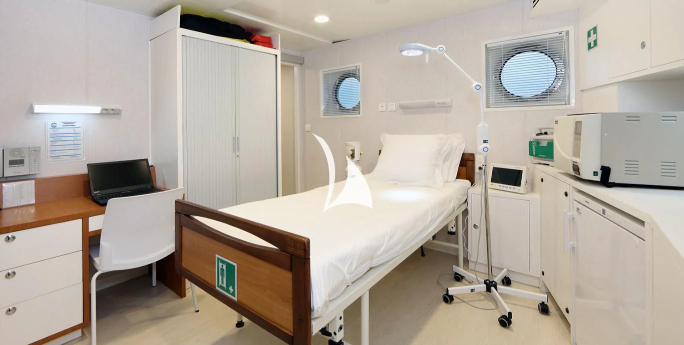 a hospital room with a bed and a desk aboard YERSIN Yacht for Charter