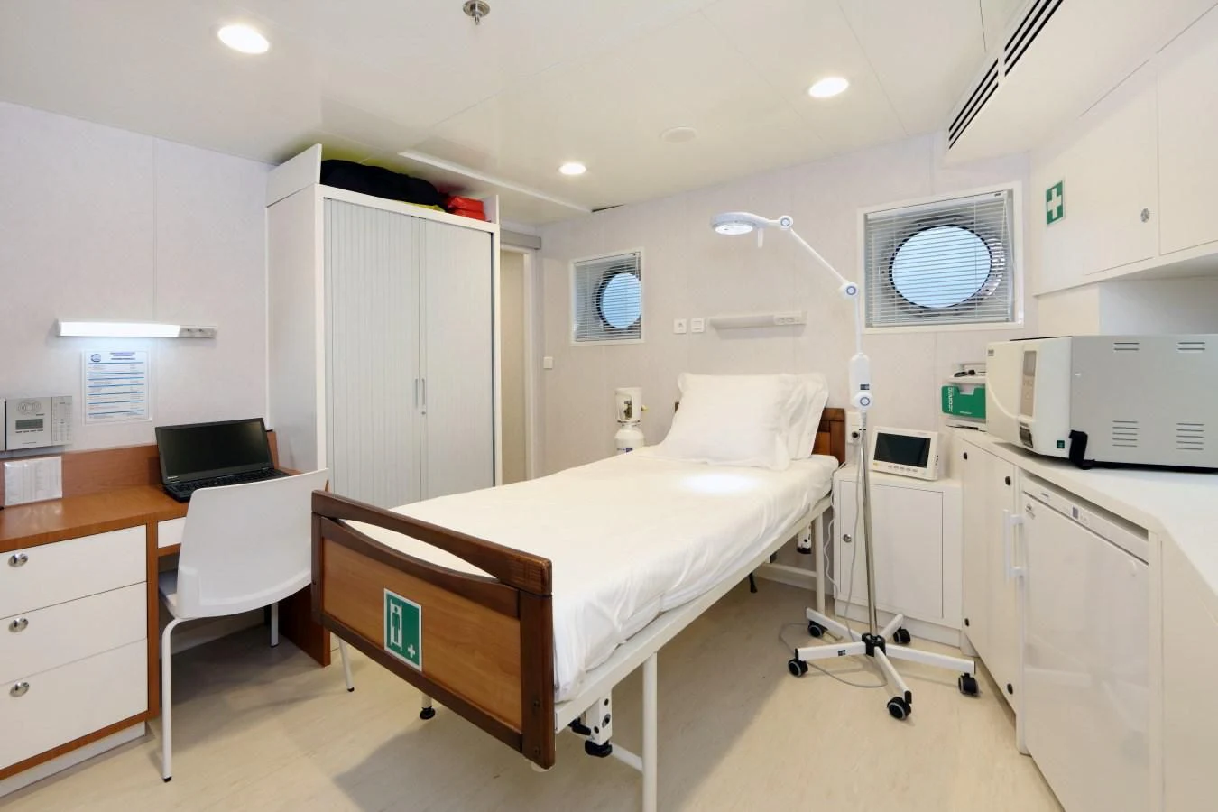 a hospital room with a bed and desk aboard YERSIN Yacht for Charter