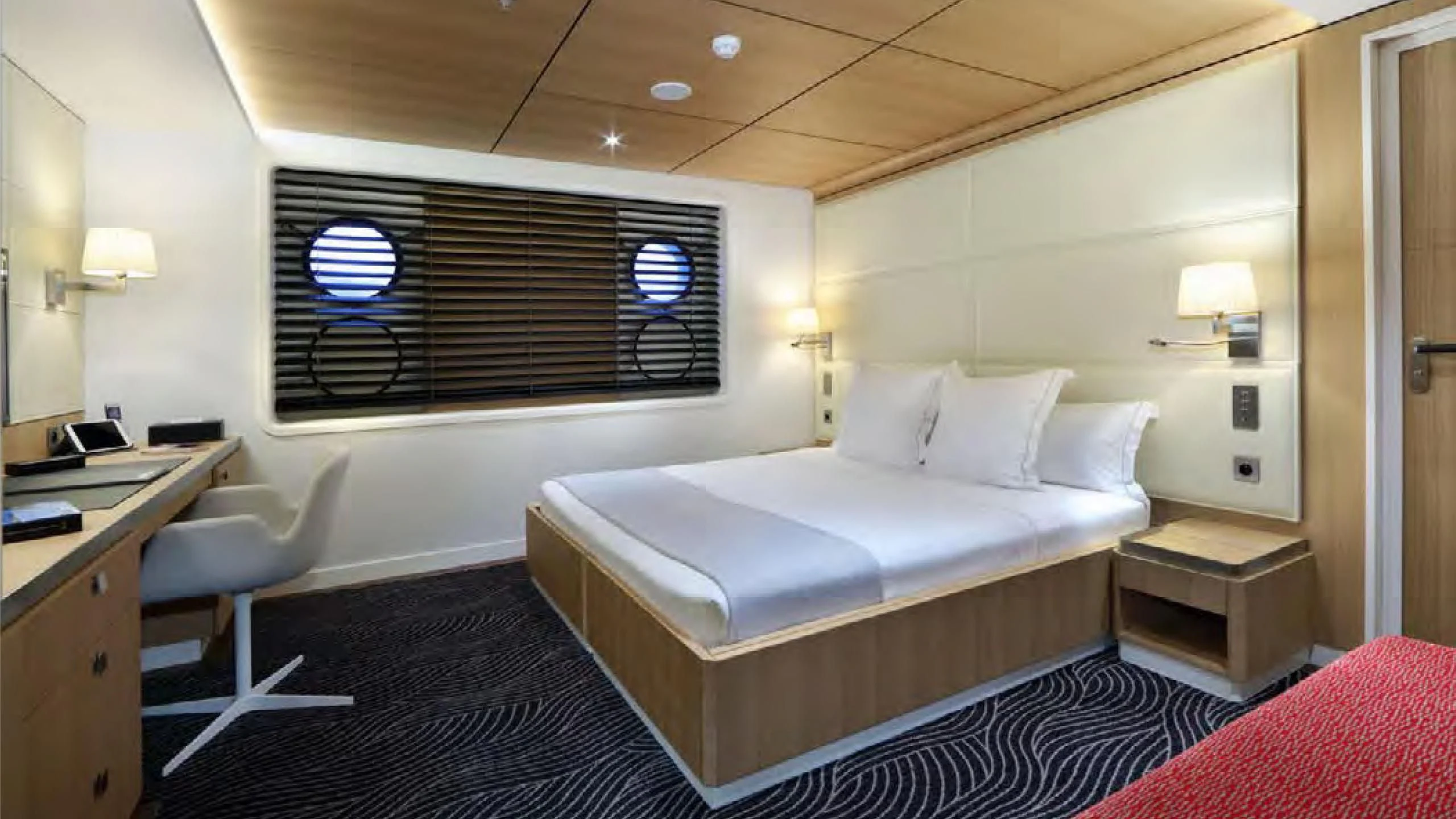 a room with a bed and a desk aboard YERSIN Yacht for Charter
